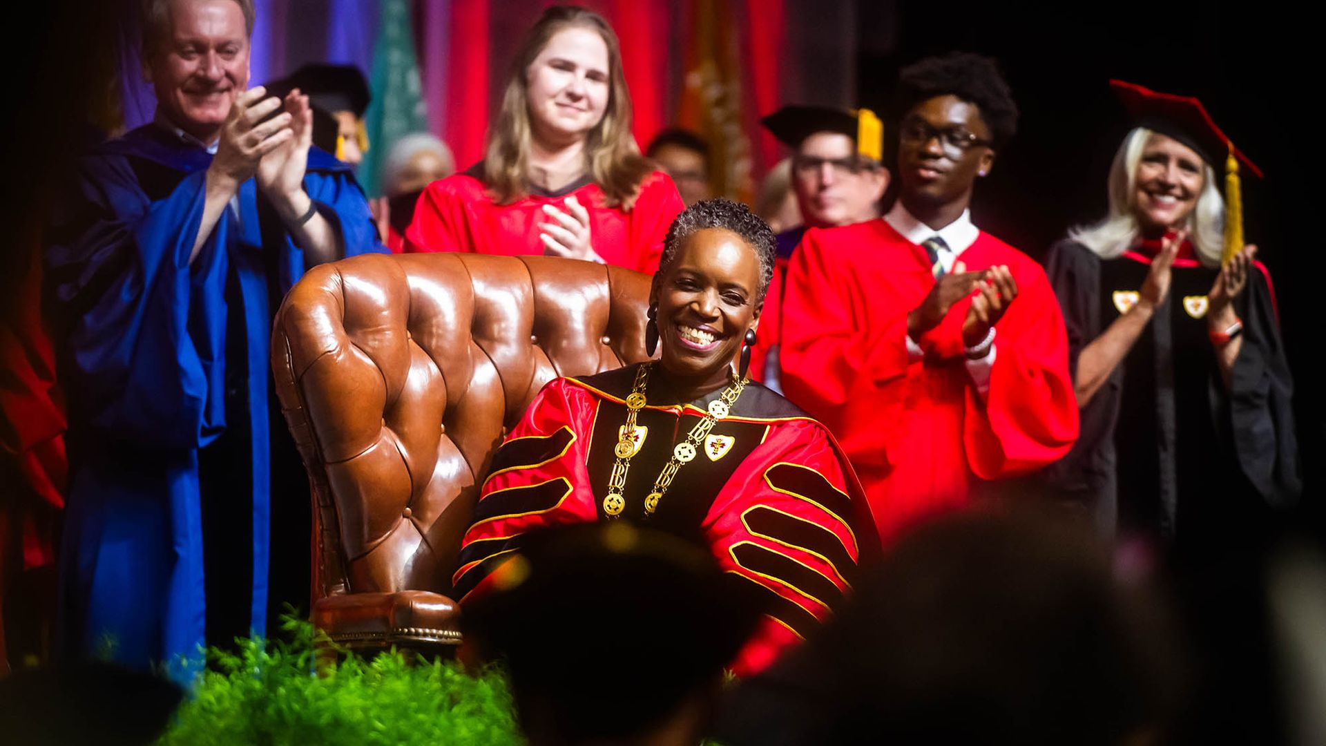 Photo: Melissa L. Gilliam sits in the leather chair that belonged to one of BU’s founders, Isaac Rich. The chair was used in 1869 when a petition was signed to charter BU as a new corporation.