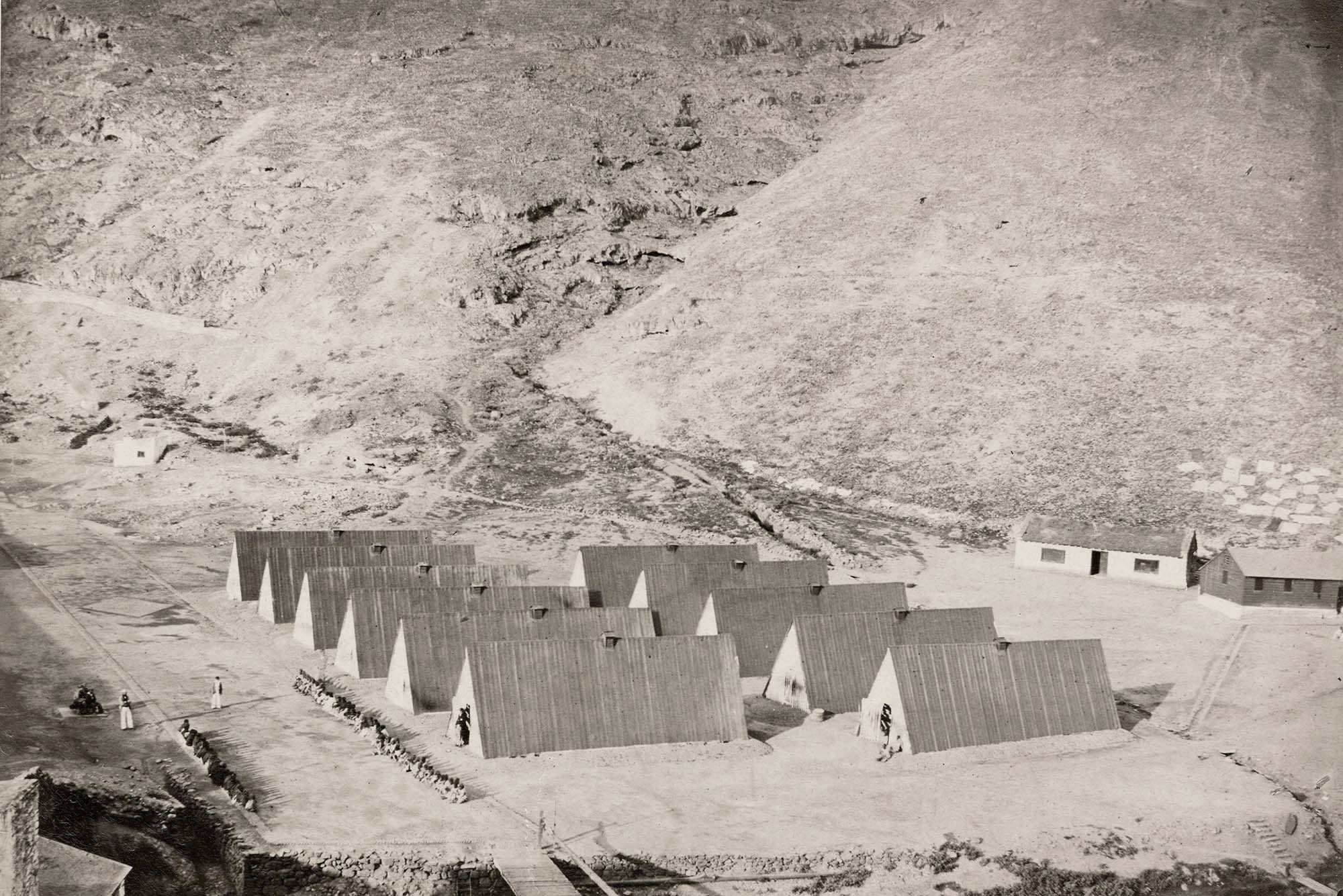 Photo: An 1850 photo of Rupert's Valley, showing the slave barracoons, and enslaved people captured by H.M.S. 'Wrangler' in Saint Helena. a
