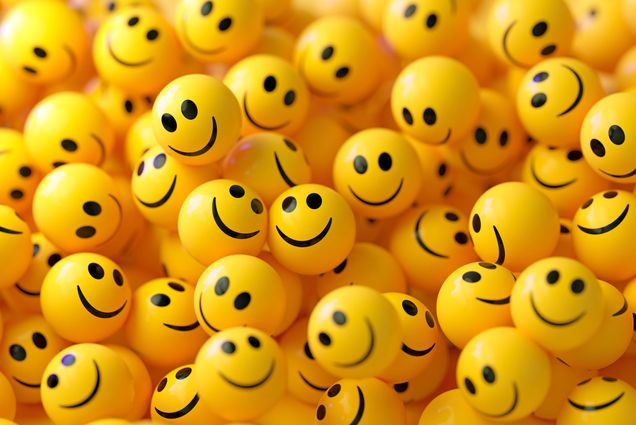 Photo: A pile of yellow spheres with smiley faces on them