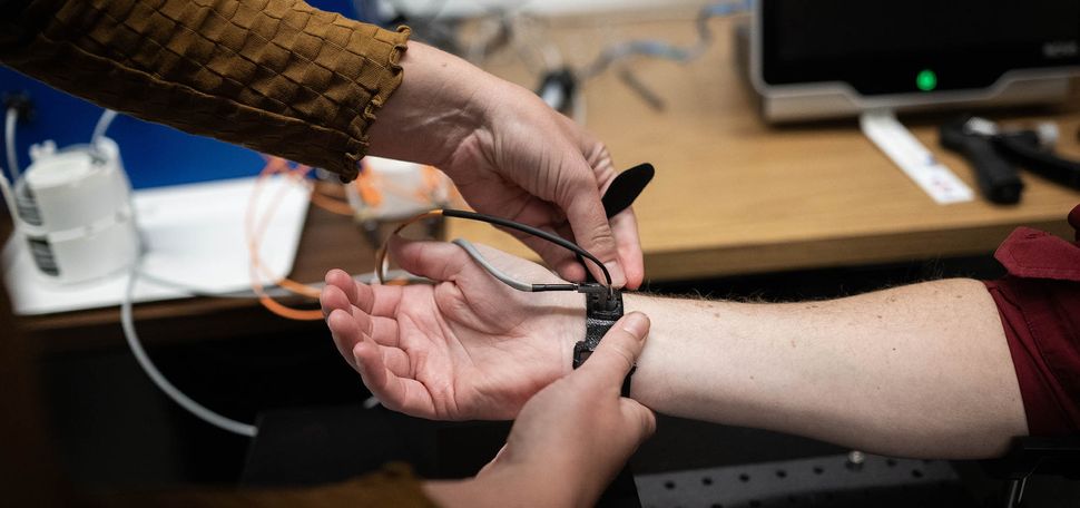 Ph.D Candidate, Ariane Garrett demonstrates how to use a cuff-less blood pressure monitor