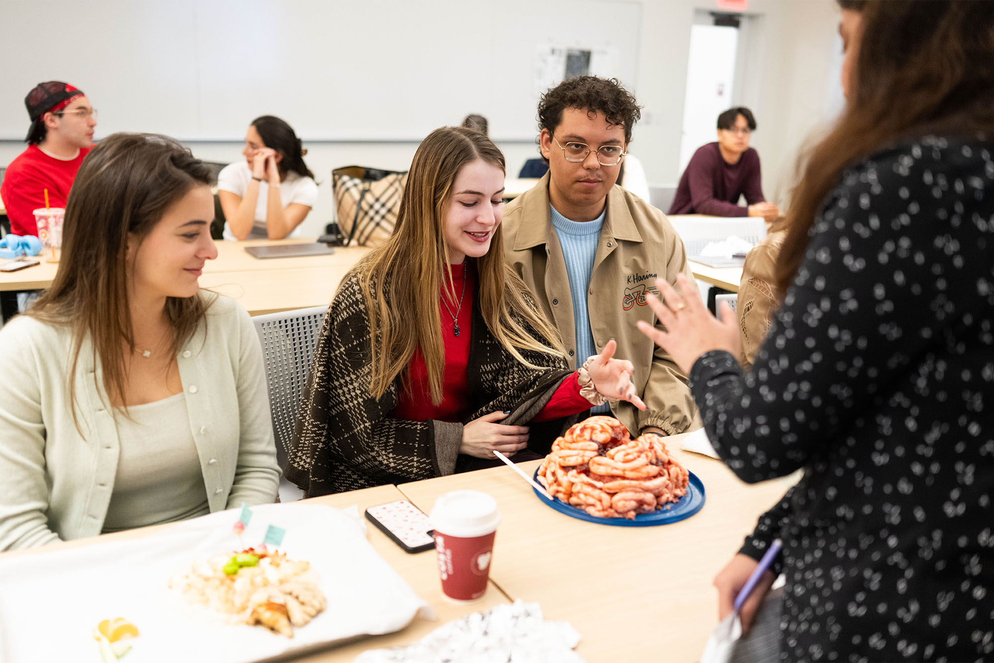 Photo: (Left to right) Matilde Camplone (CAS 25), Lucy Godinez (CAS 25) and Andre Weiss participate in an Edible Brain Competition on November 19, 2024