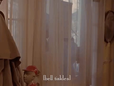 A GIF from the show Gilmore Girls, where someone opens the front door to Lorelai and Rory standing there and the person greeting them says "uh the gilmore's. happy thanksgiving"