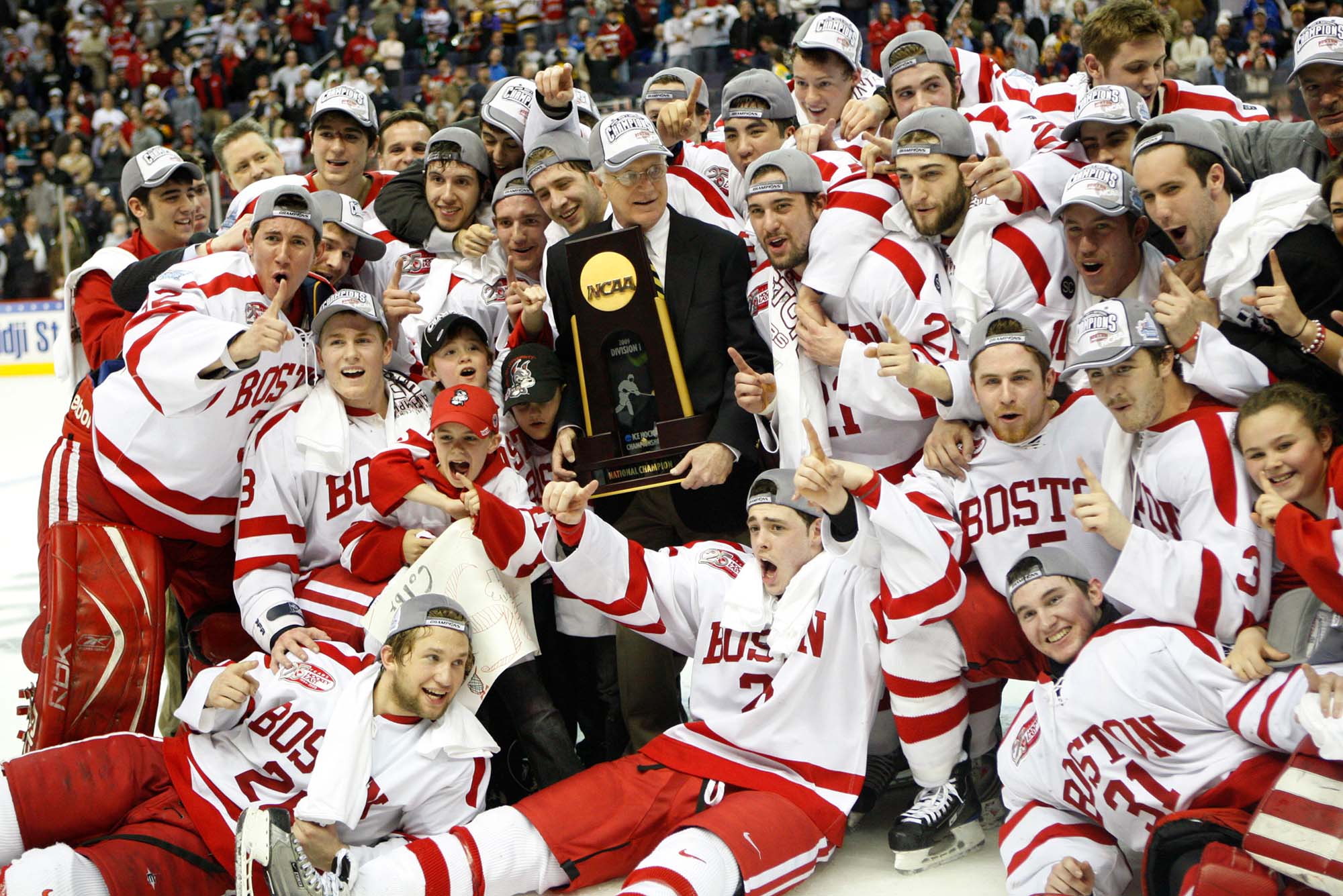Photo: The Boston University Men's Hockey team celebrating their 2009 championship victory on the ice with their trophy
