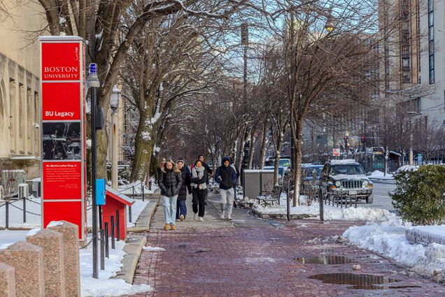 Photo: A group of college students walking down a snowy street on an overcast day