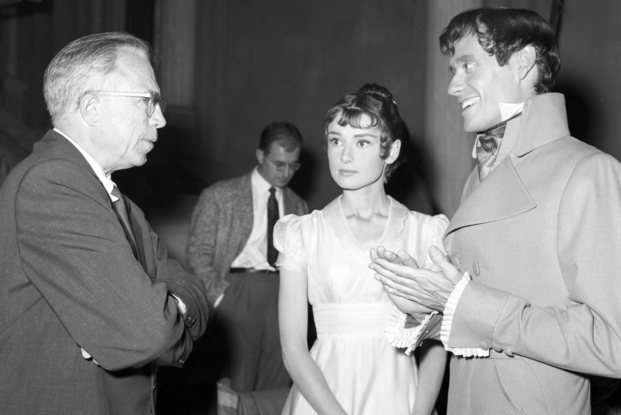 Photo: A black-and-white picture of King Vidor, Audrey Hepburn, and Mel Ferrer on the set of "War and Peace"