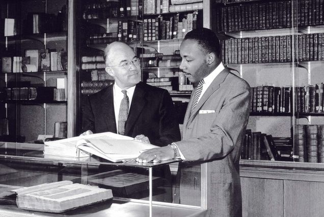 Photo: A picture of a BU professor (left) and MLK Jr. looking at a book in a library
