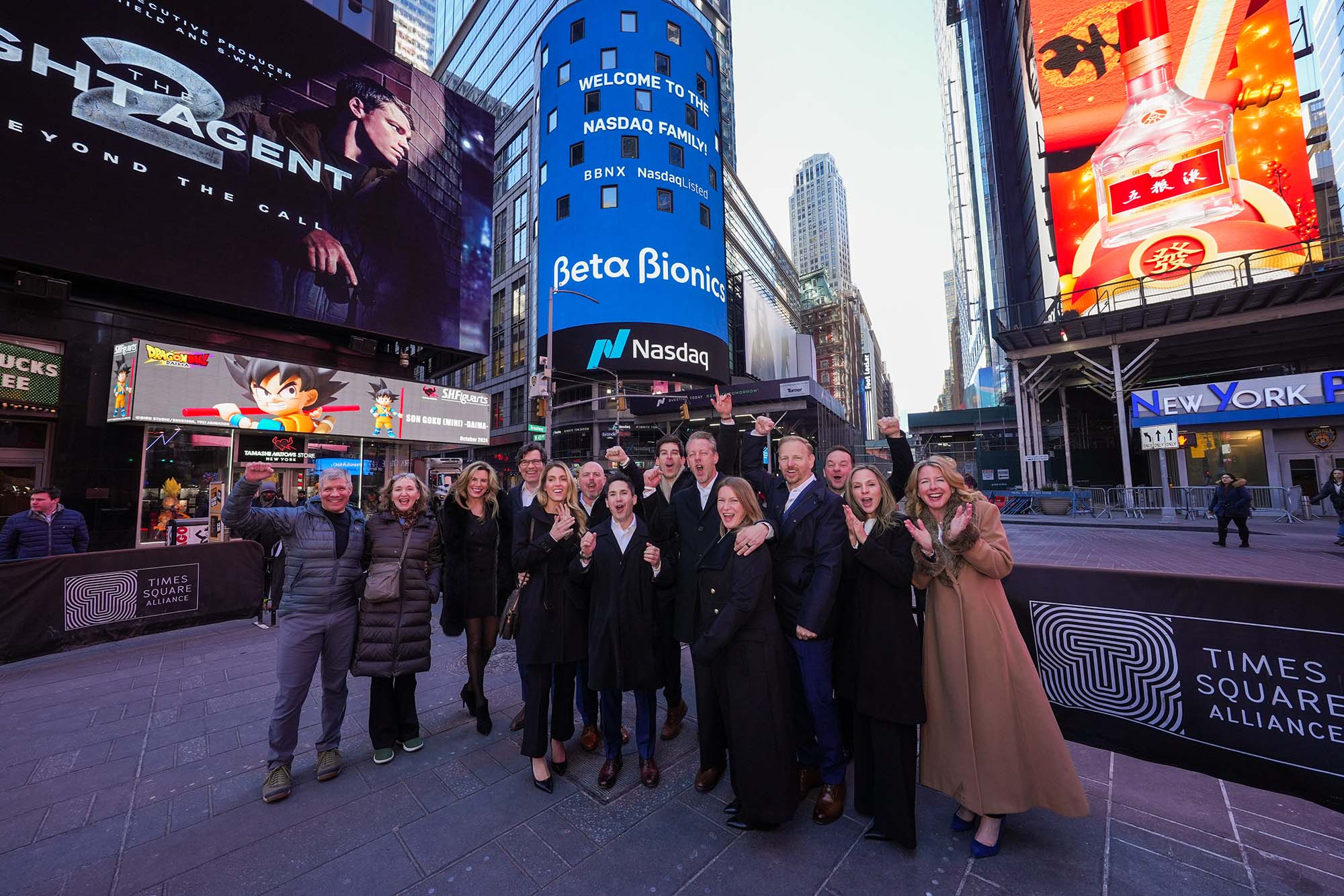 Photo: A group of people standing and cheering in the middle of Times Square