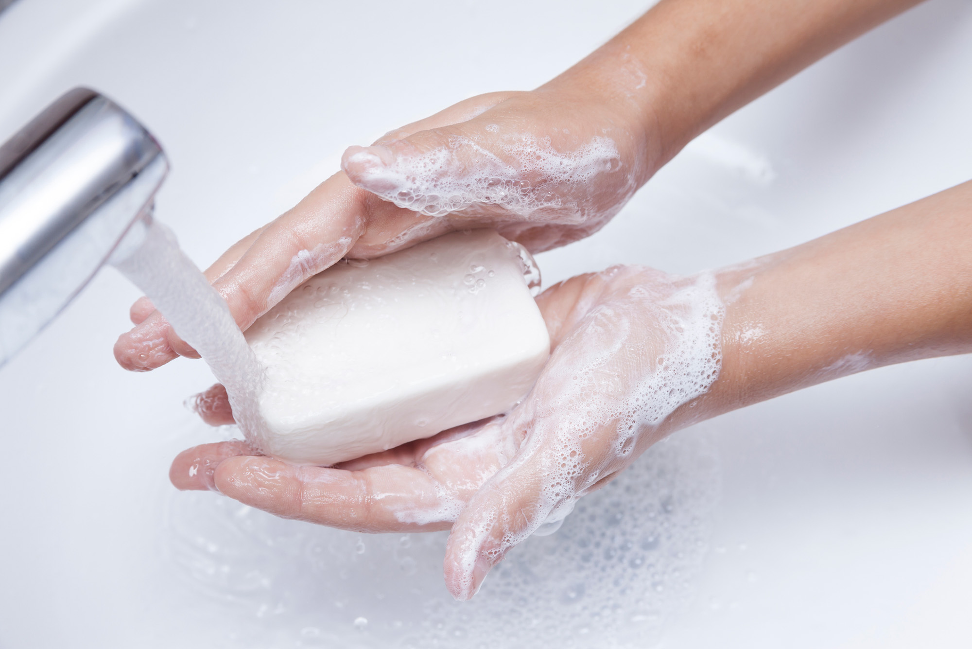 Photo: A person washing their hands with a bar of soap