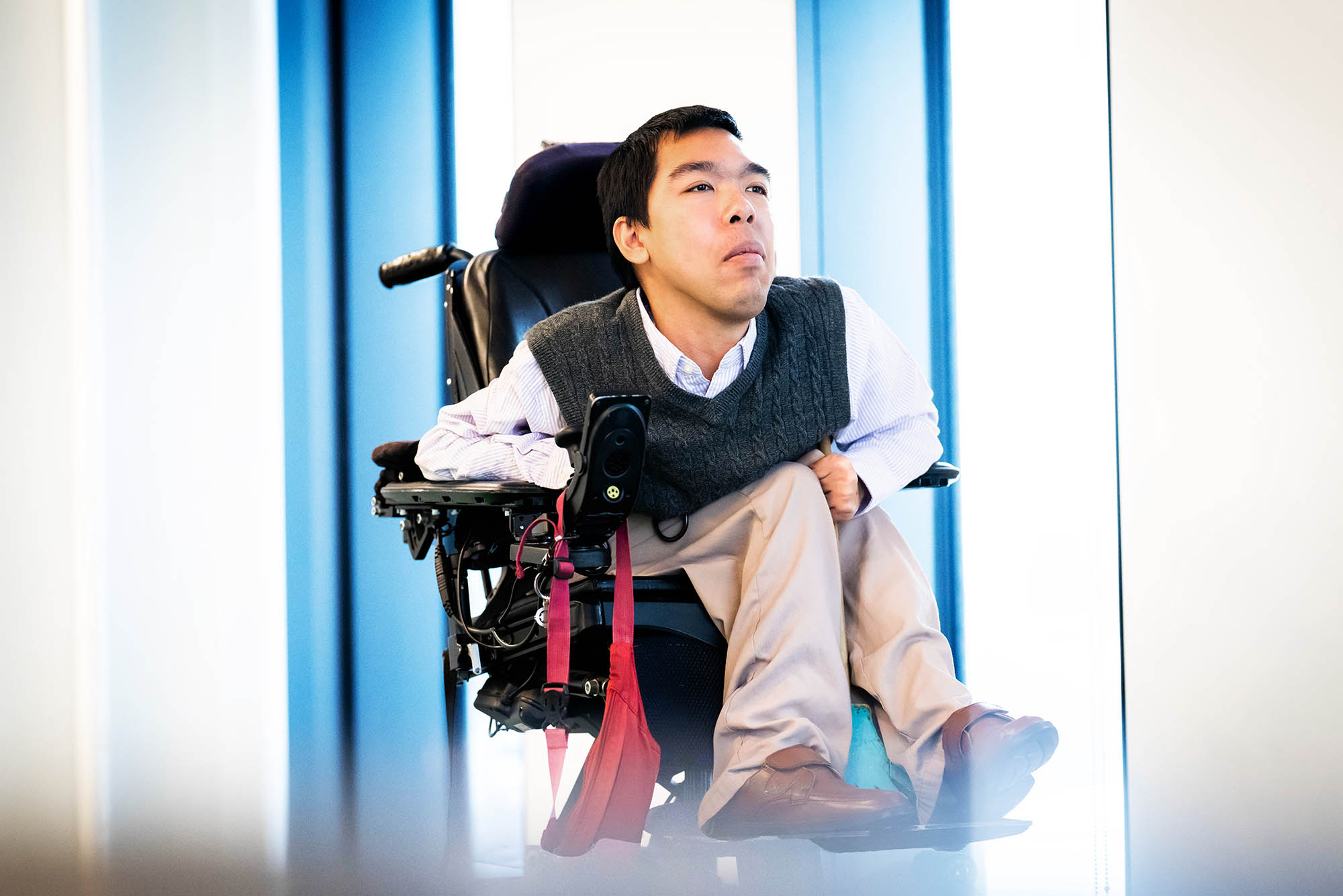 Photo: PhD student Justin Moy poses for a portrait photo in a vest and white button up
