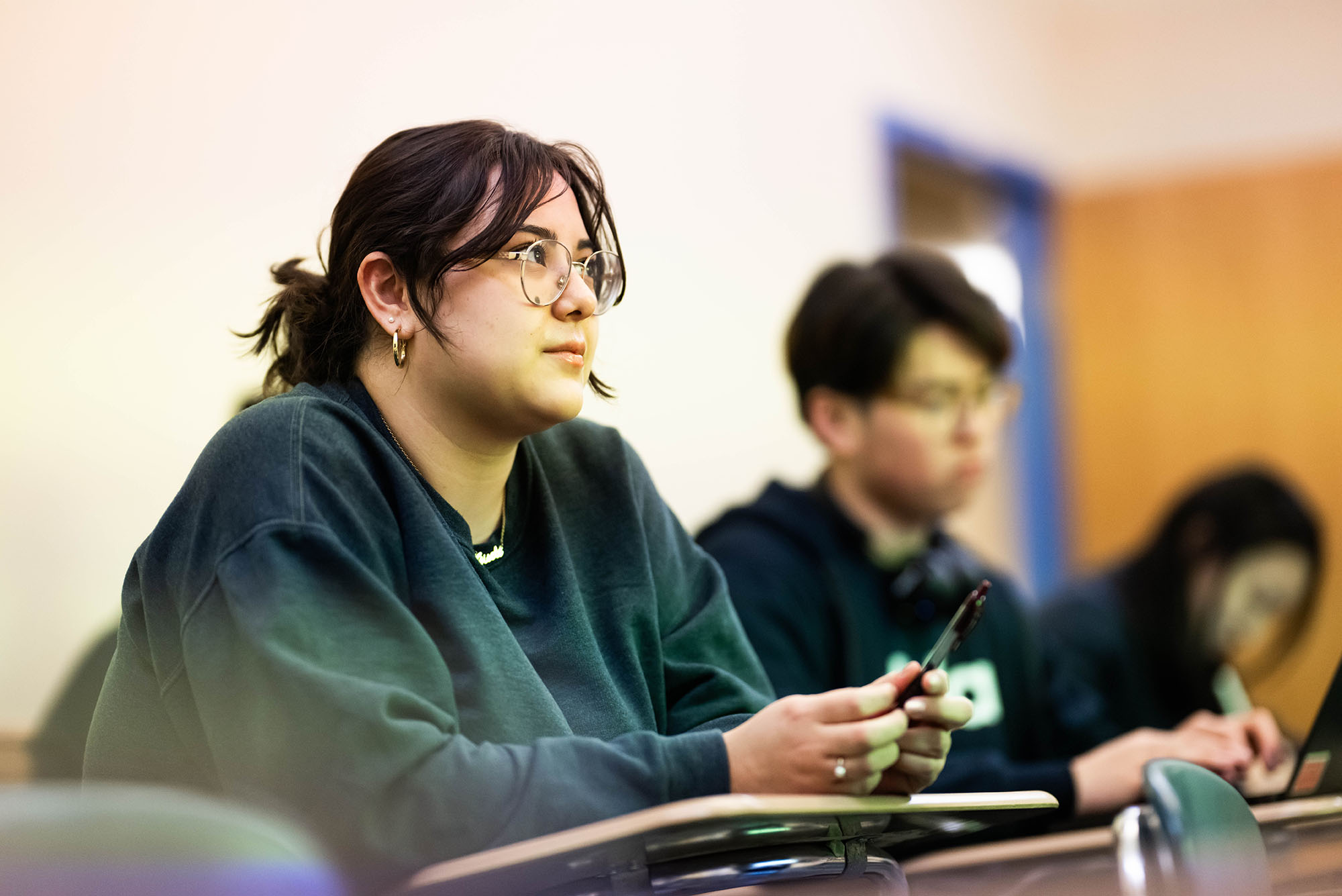 Photo: Three students sitting in a classroom