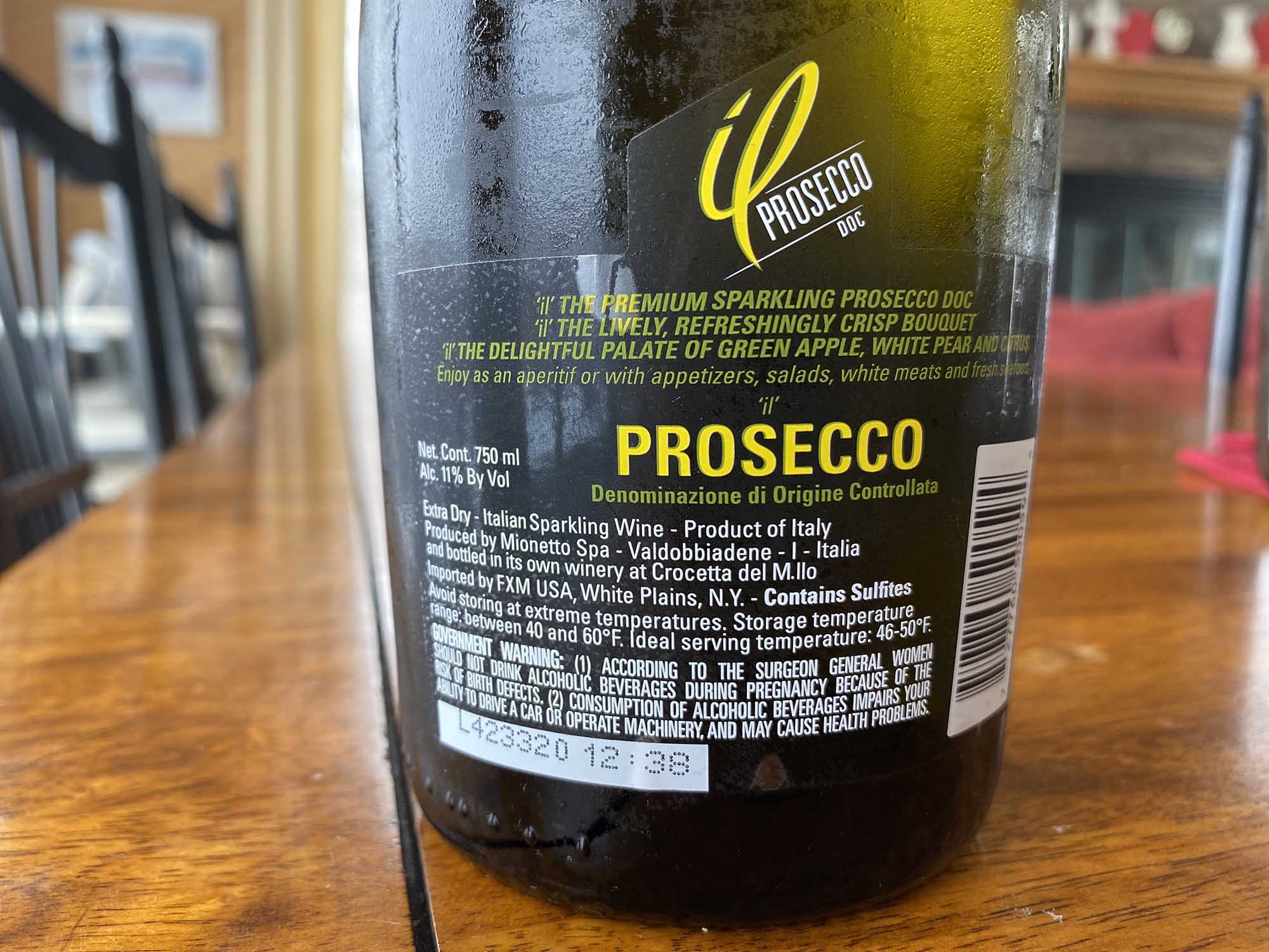 Photo: A close portrait of the warning label on a bottle of prosecco.