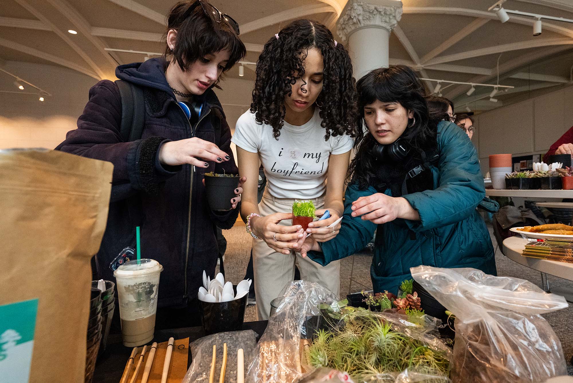 Photo: Three female BU Students making a terrarium at an event