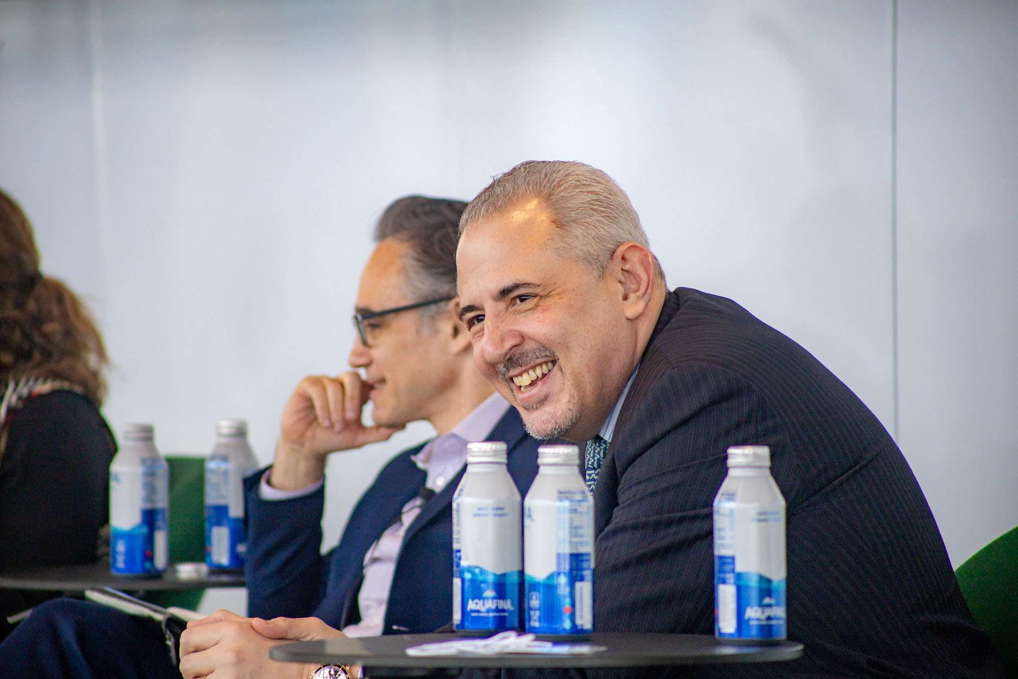 Photo: Panelists smiling in front of a crowd