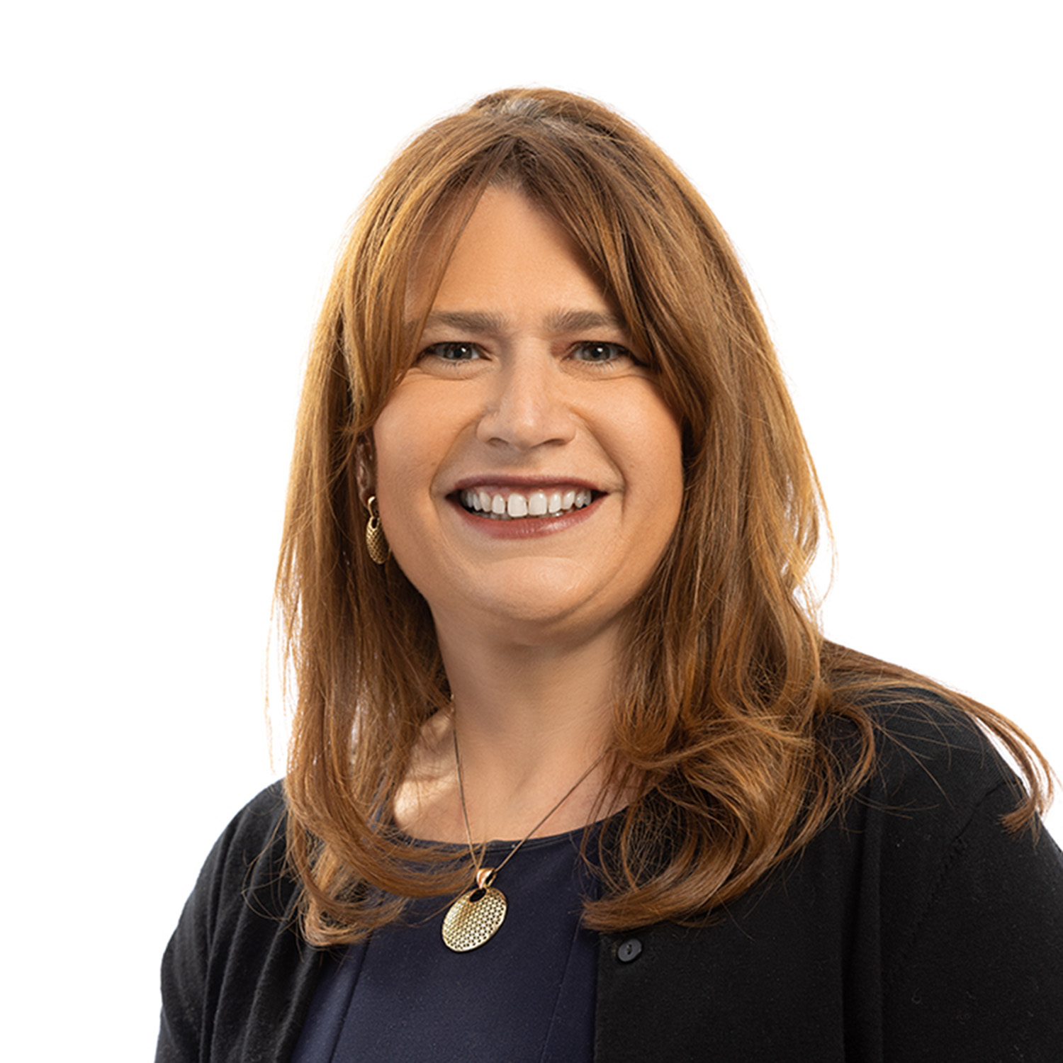 Photo: A woman smiling for a headshot in front of a white background