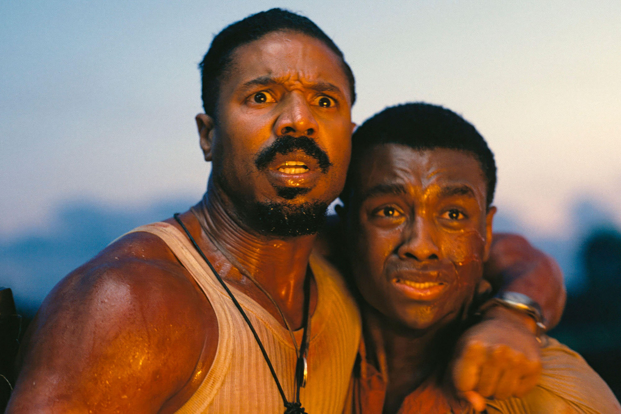 Photo: A still from the movie "罪人" with two men looking off into the distance afraid