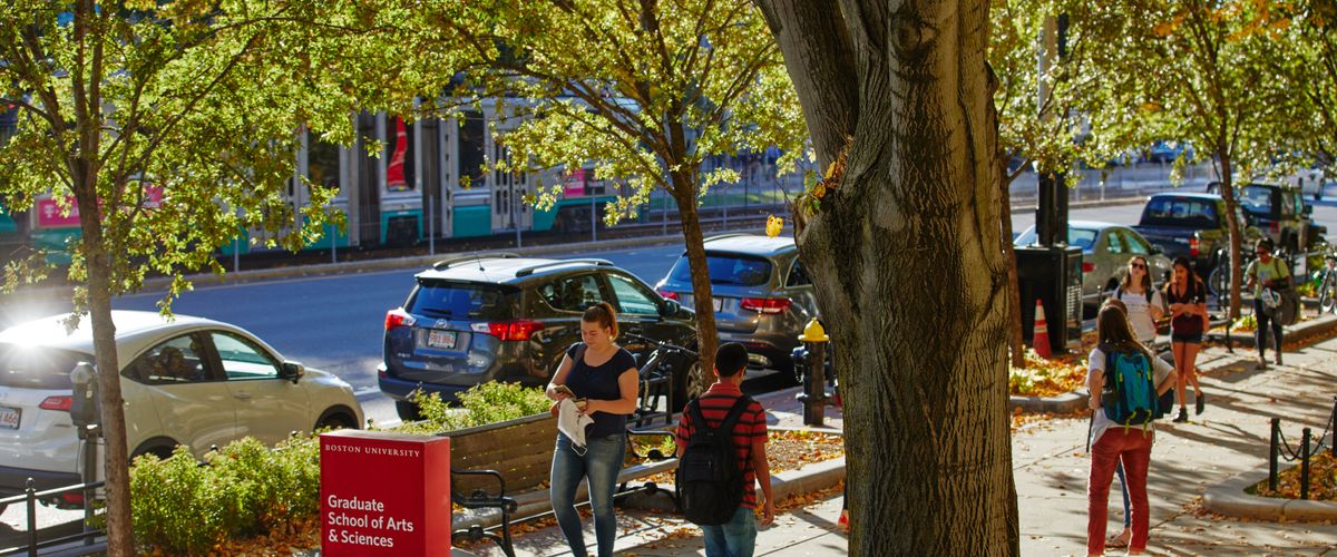 Students walking on sidewalk in fall