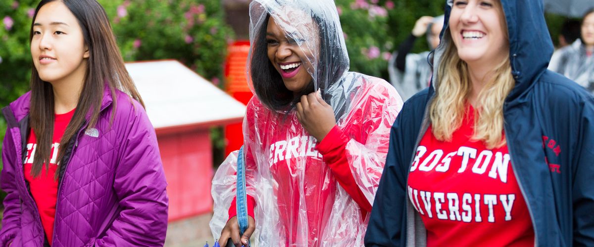 Three female students in the rain