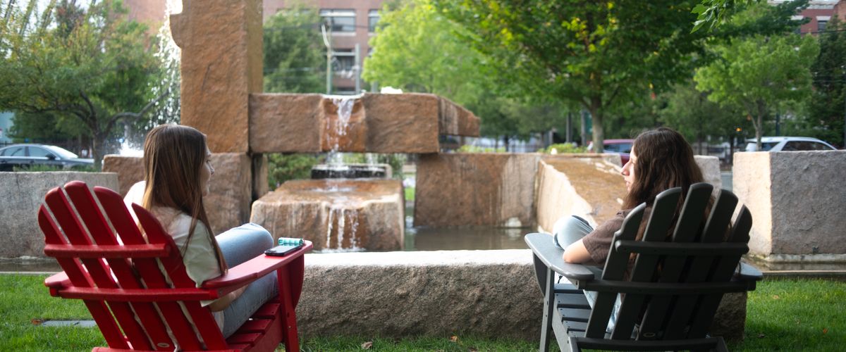 Students seated in lawn chairs