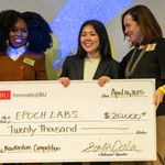Photo: Three women holding up a check at BU Innovators' Night