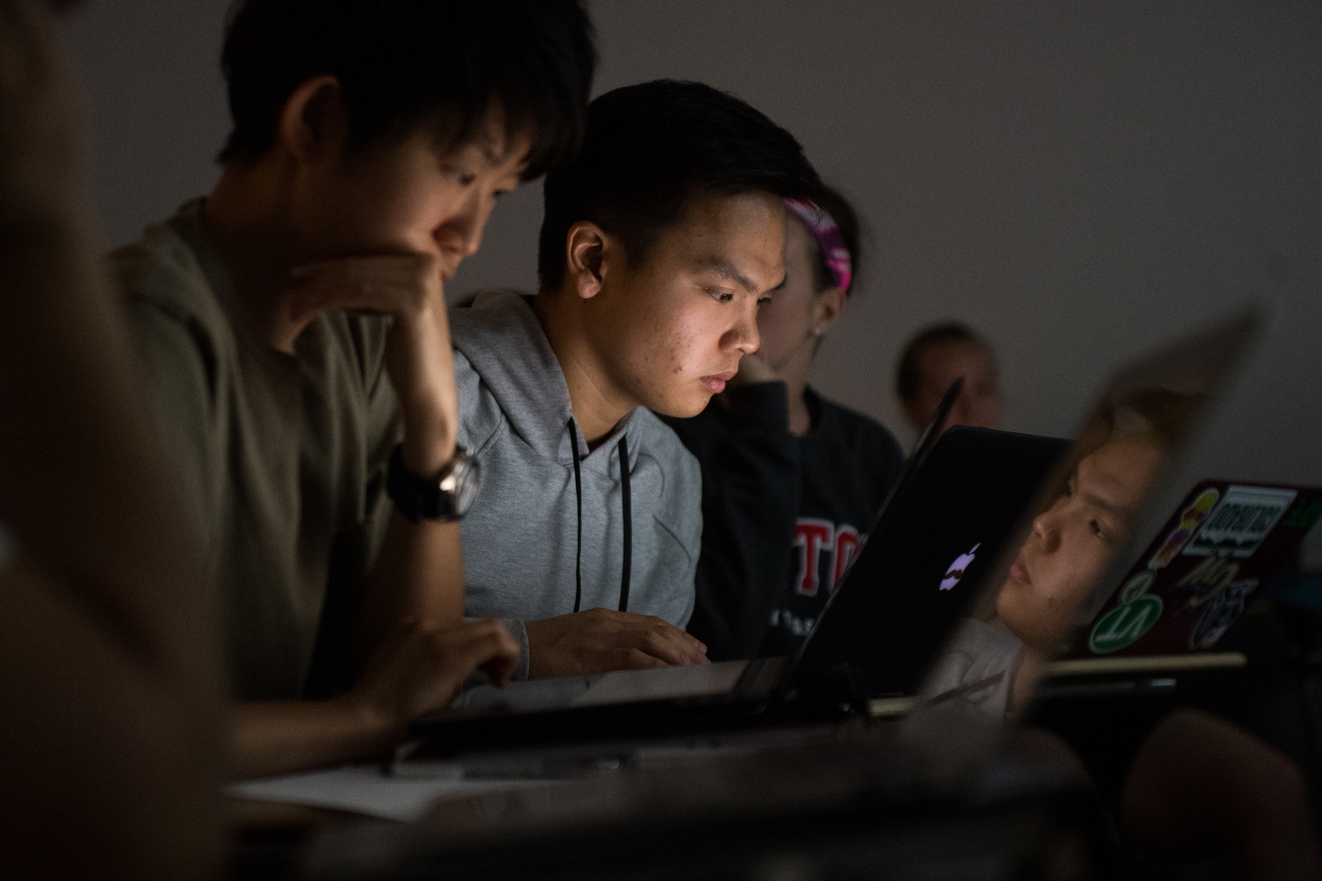 Student is looking at his laptop in a classroom