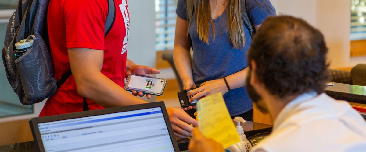 photo of students checking in at front desk
