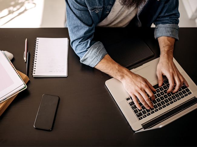 Young casually clothed man working on a laptop