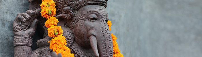 Ganesha with balinese Barong masks, flowers necklace and ceremonial offering