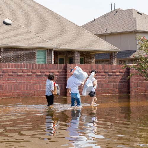 People walking through flooded street