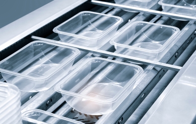 Plastic containers on a conveyer belt.