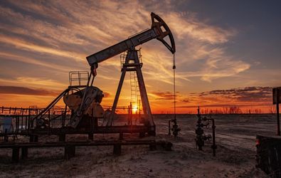 Oil rig machine at sunset.