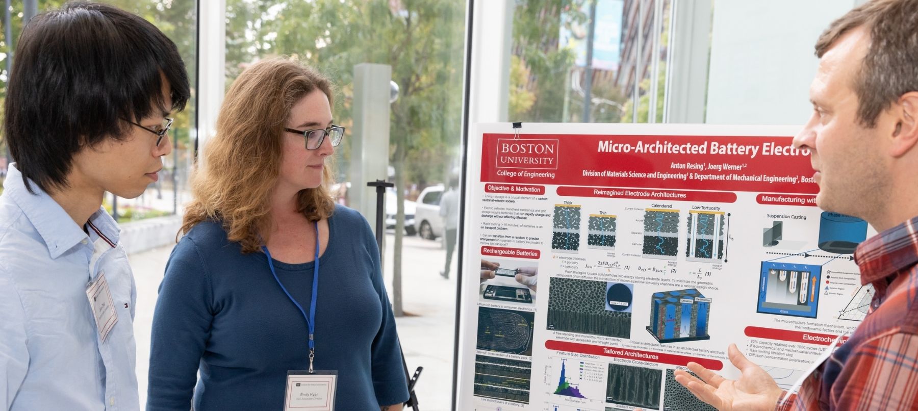 People looking at a research poster.