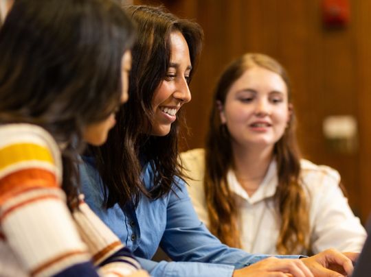 Closeup of students working together on the computer.