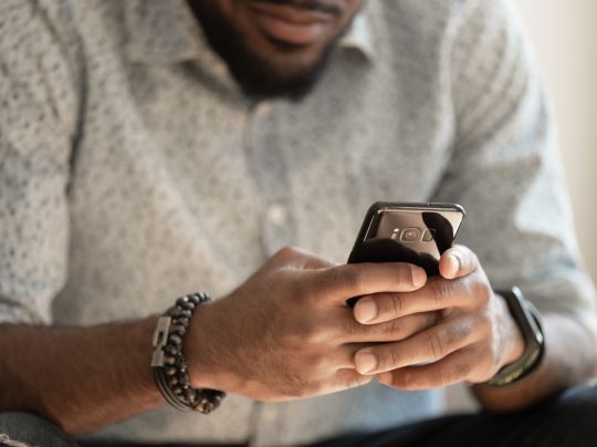 Close-up of a person holding a cellphone.
