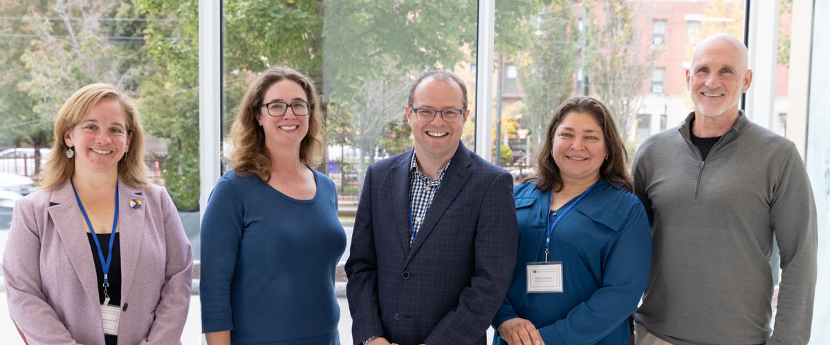 Group of IGS professionals smile for photo.
