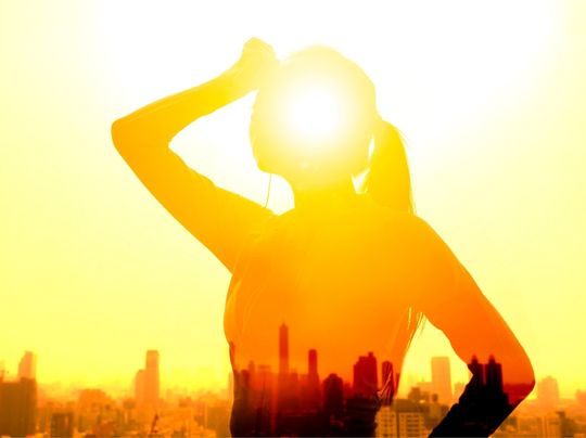 Woman in a hazy heat wave in an urban area