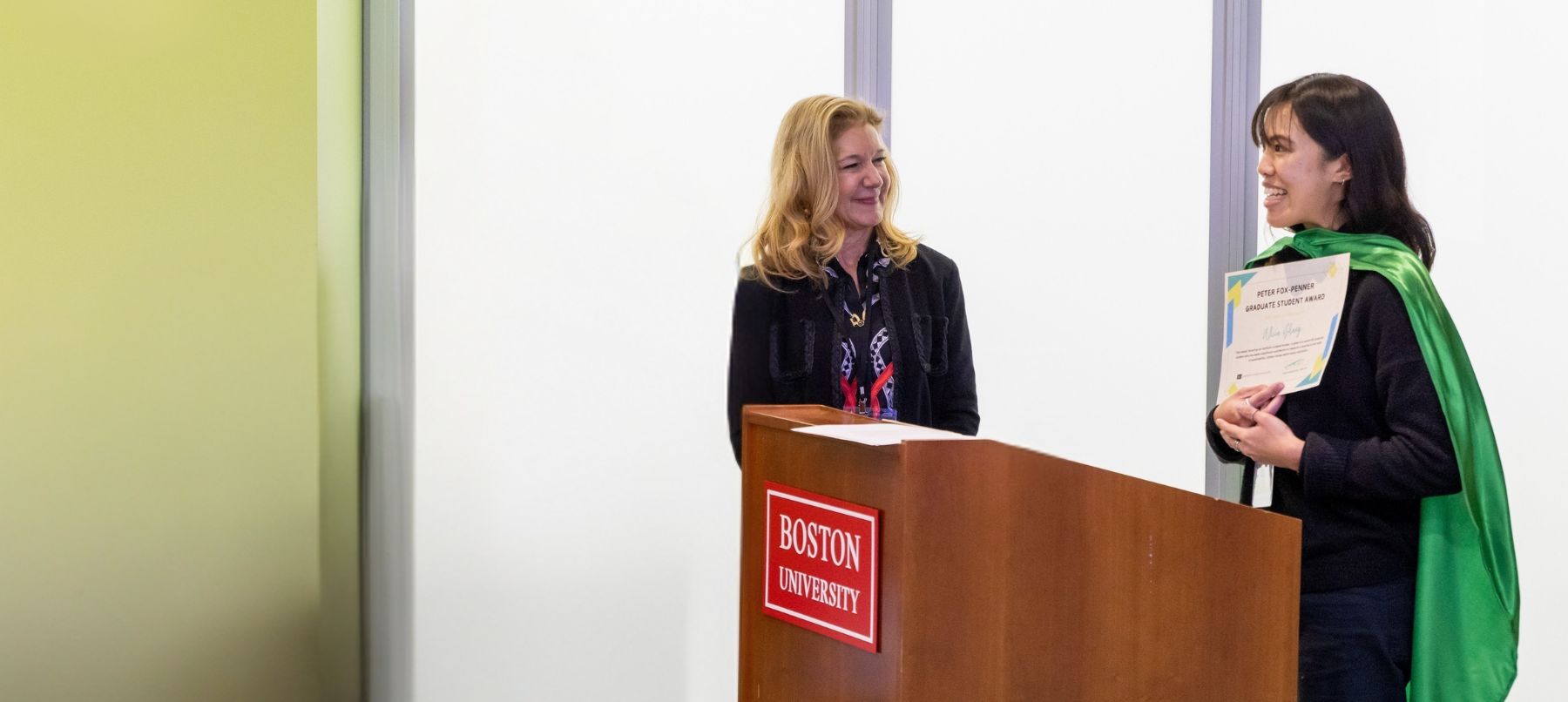 Student receives award certificate at a podium.