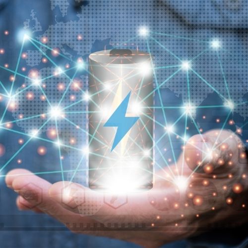 A battery icon in a palm, with a network graphic surrounding it.