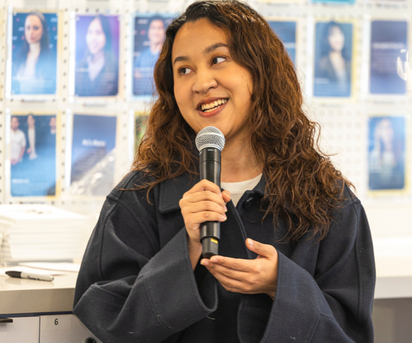 Smiling while talking into microphone