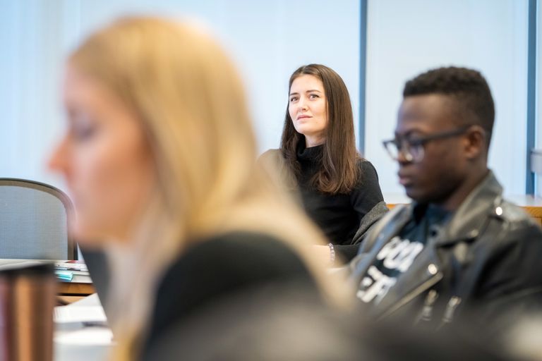 three law students focused on a lecture in