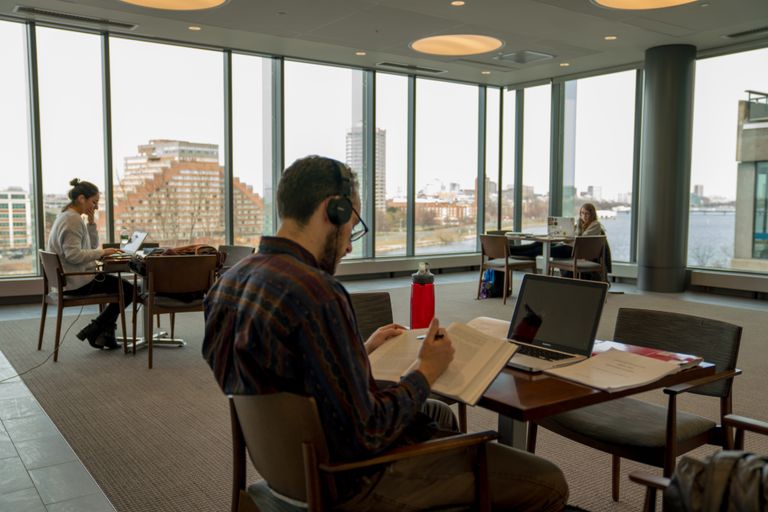Smattering of students studying in the law library with 360 picture windows
