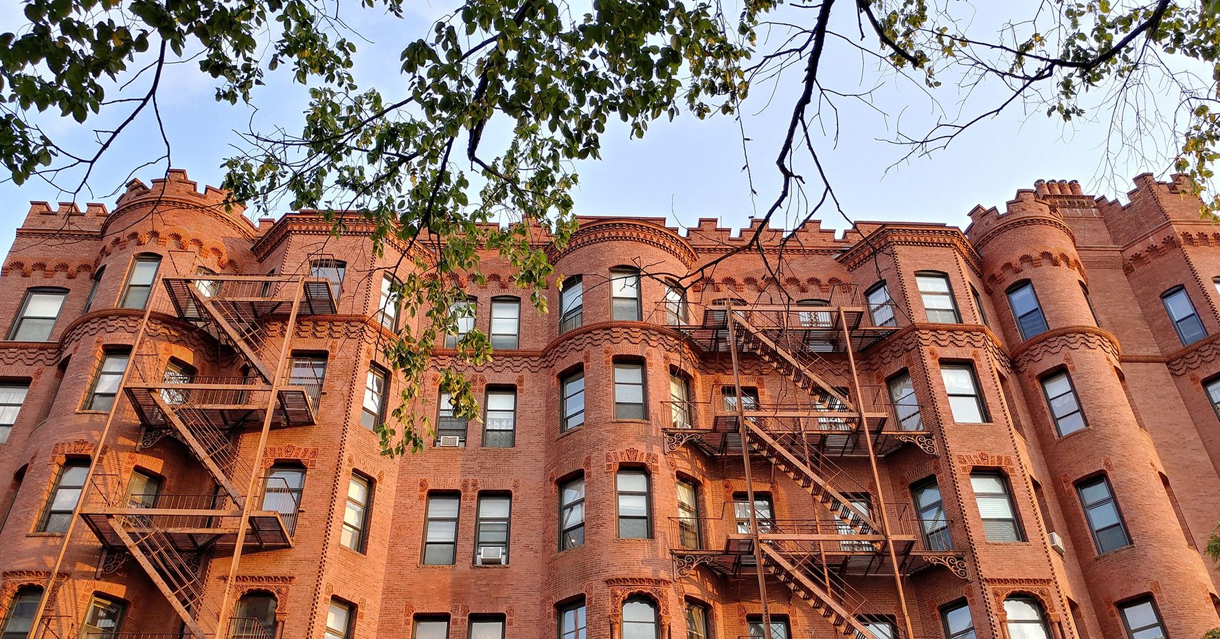 An angled view of a brownstone apartment building in Boston.