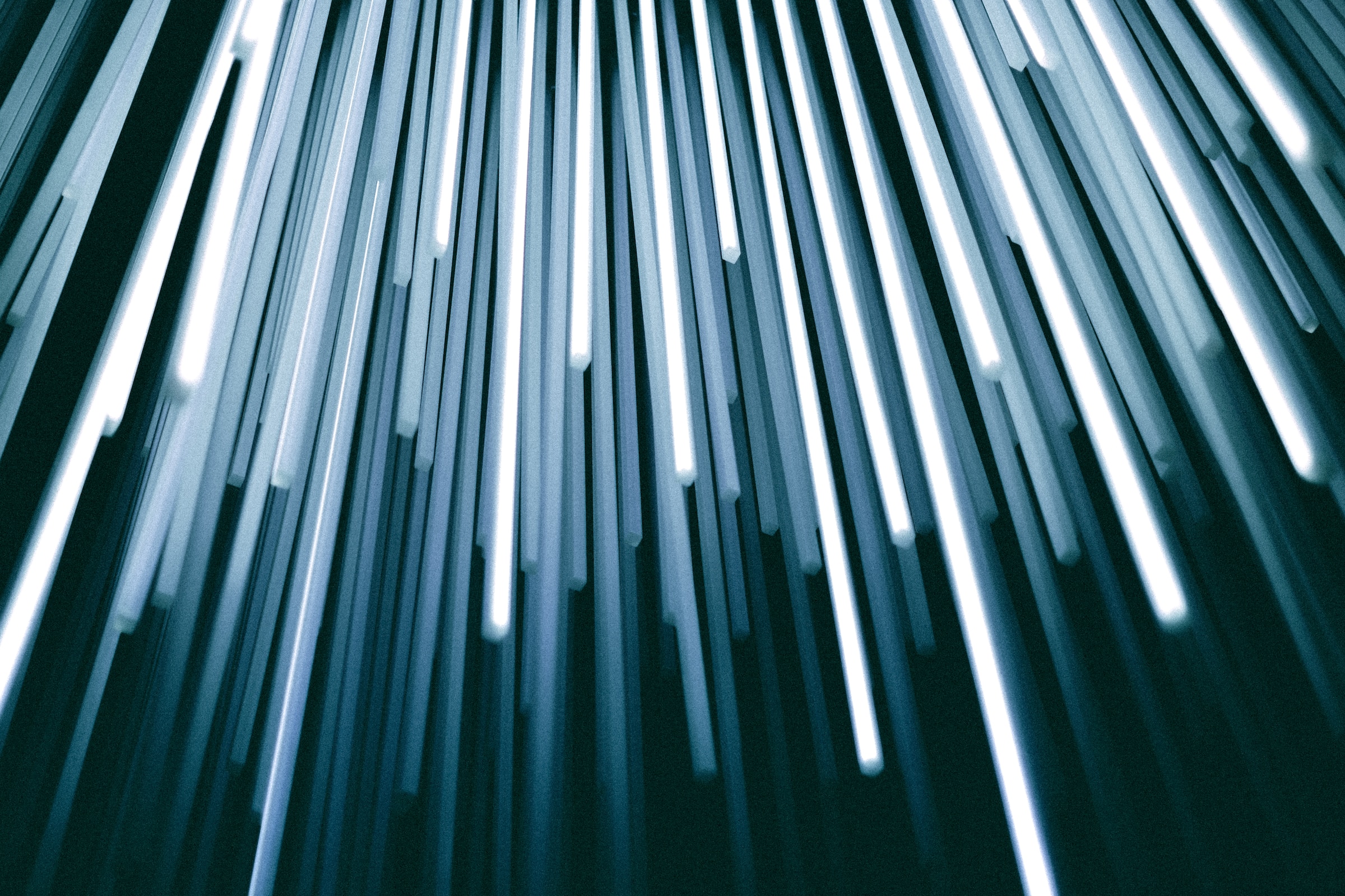White and blue fiberoptic lights against a black background