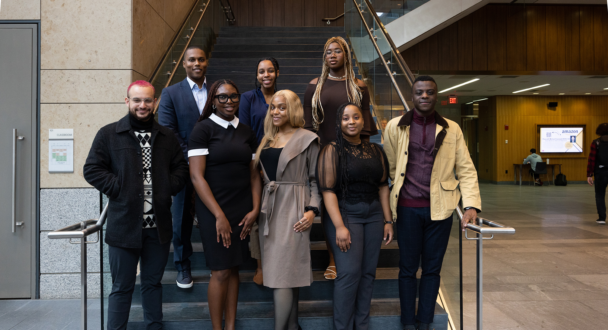 Members of a student organization pose for a picture in the atrium of the law tower.