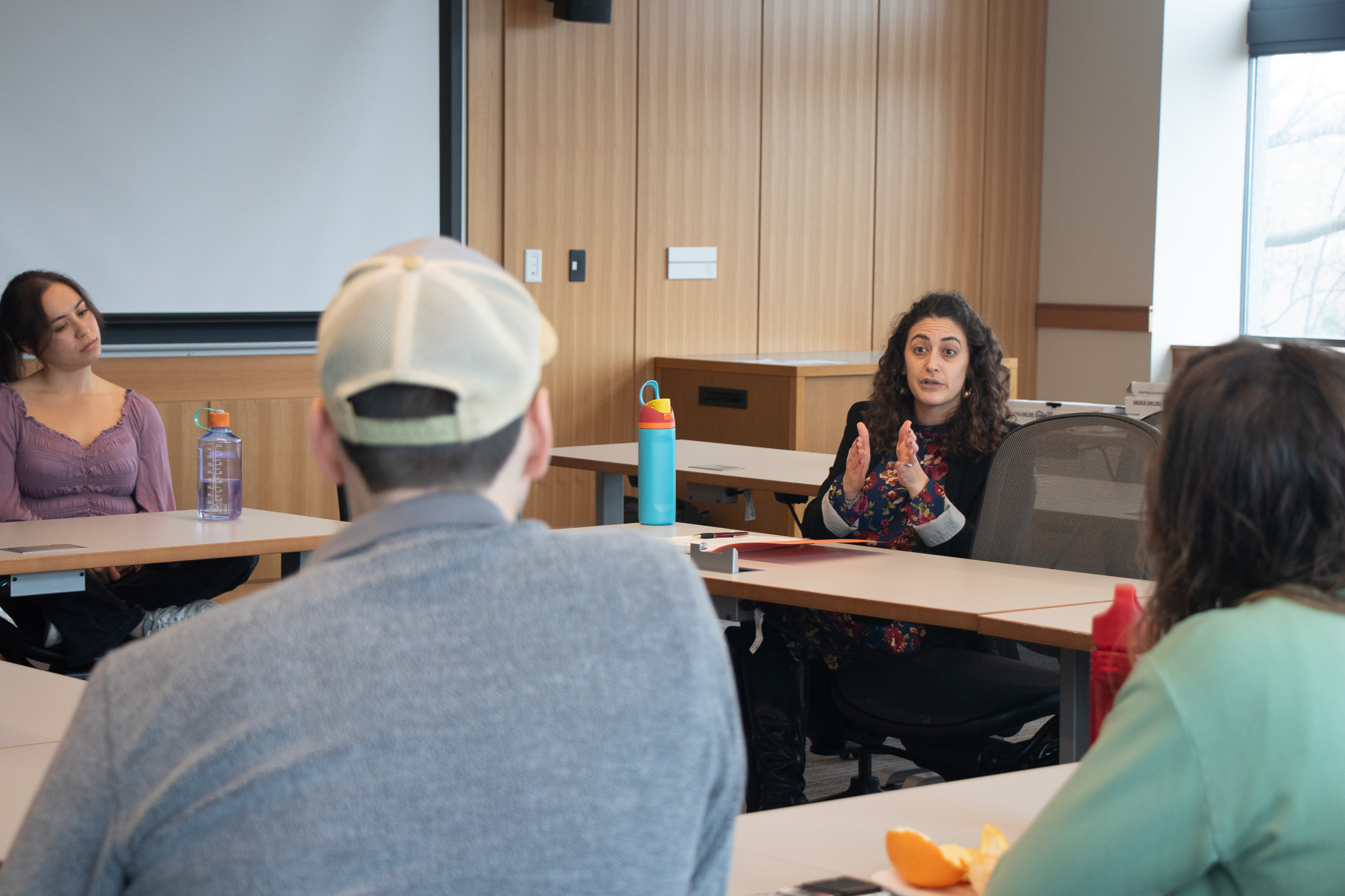 Professor Maddie Meth speaking to students in her clinic.
