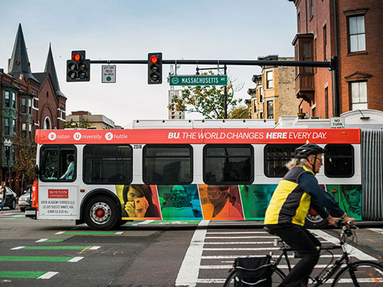 Image of a bus turning on a city street.