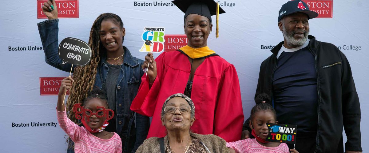 A recent graduate poses with her family during the 2020 MET Recognition Ceremony