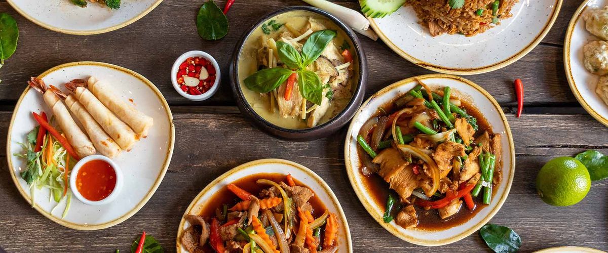 Various Thai food dishes spread across a table