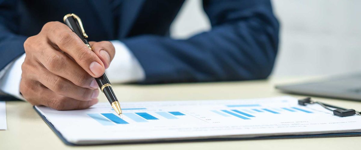 Closeup of a man in a analyzing financial data at a desk