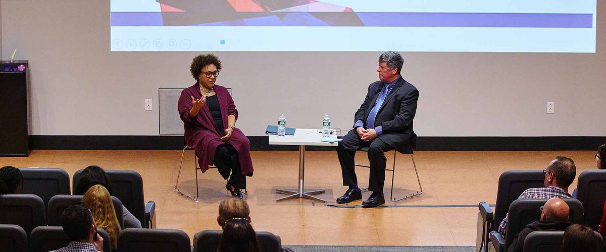 Dr. Maria Rosario Jackson, Chair, National Endowment of the Arts speaks with MET College's Doug DeNatale after delivering the second Annual Daniel Ranalli Lecture.