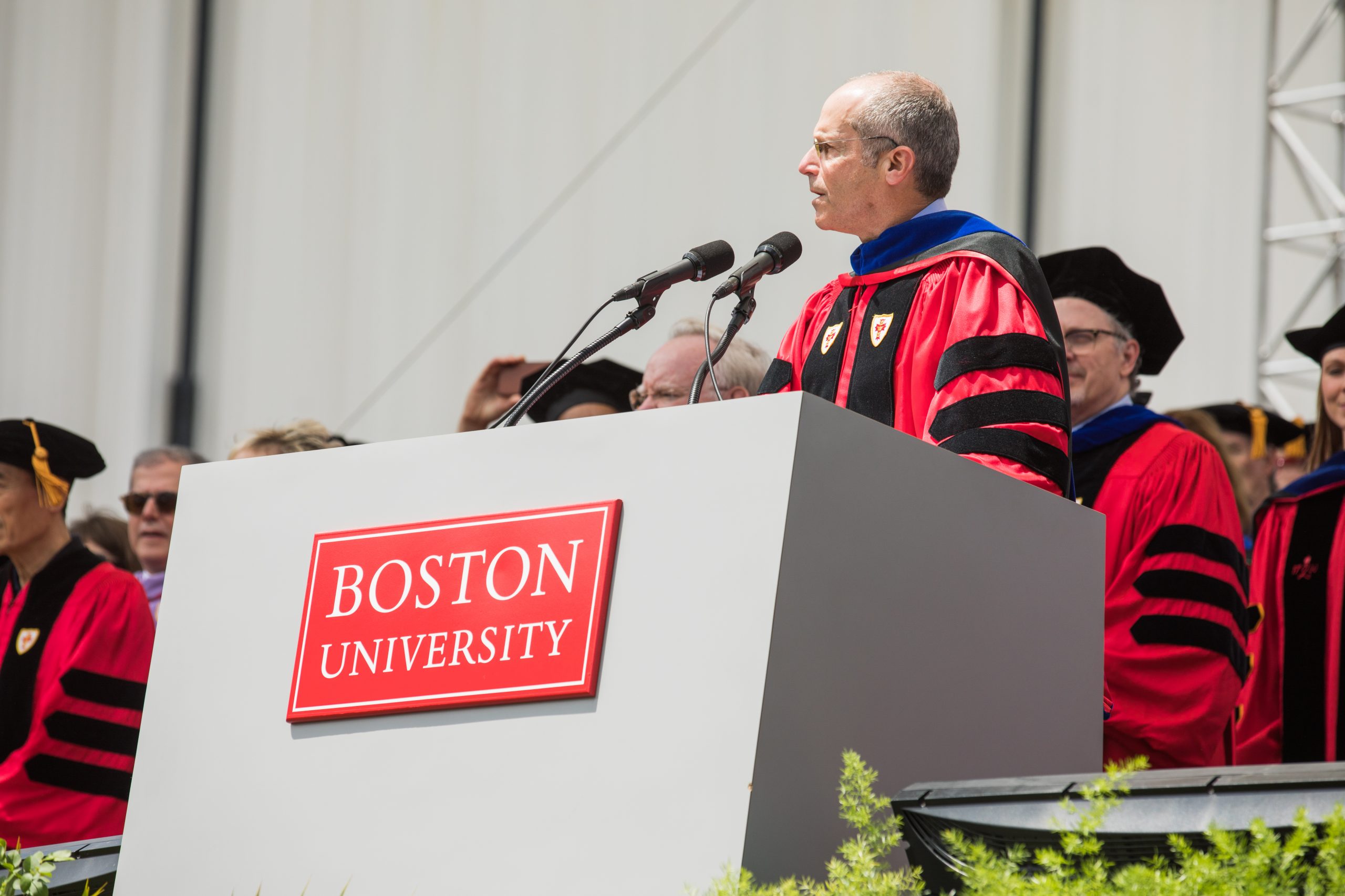 Chairman of the Board of Trustees, Kenneth Feld performs the Call to Order at the beginning of the 2018 Boston University Commencement on Nickerson Field on May 20, 2018.